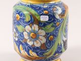 a blue vase with yellow and white flowers on it