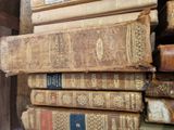 many old books stacked on top of each other