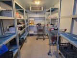 a room with a lot of shelves and carts in it