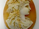 an image of a woman ' s profile is shown in a carved shell