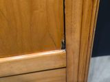 a close up of a wooden cabinet with a drawer underneath it