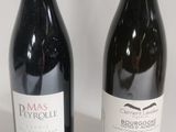 two bottles of wine sitting next to each other on a table