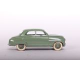 a green toy car that is sitting on a table