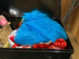 a black trash can with a blue plastic bag in it