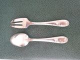 two spoons and a fork sitting on a table