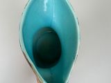 a blue vase with a design on it on a table