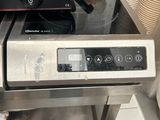 a silver stove top with a black burner on top of it