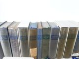 a lot of books that are sitting on a shelf