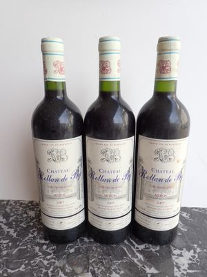 three bottles of wine sitting on top of a table next to each other