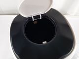 a black and white toilet with a white lid