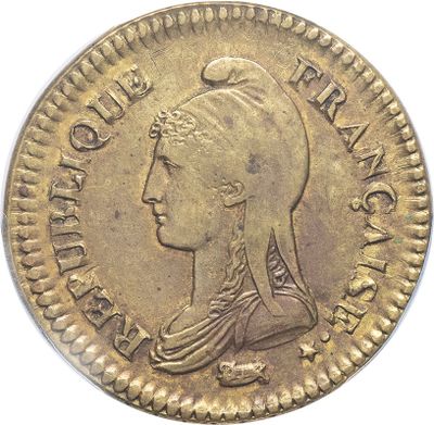 a gold coin with an image of a woman wearing a headdress