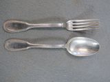 two silver spoons and a fork on a table
