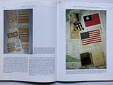 an open book with a picture of an american flag and other items on it