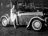 a black and white photo of a woman sitting in a car