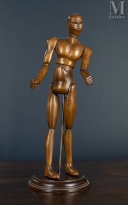 statue of a man standing on a pedestal with a stick in his hand