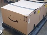 a cardboard box on a pallet with a smiley face drawn on it