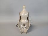 a white vase that is sitting on a table