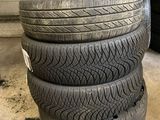 four tires stacked on top of each other in a garage