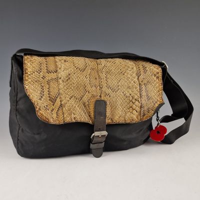 an image of a snake skin purse with a black strap