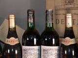 several bottles of wine are lined up on a table