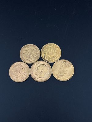 six different british coins on a black surface