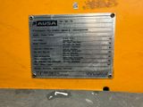 a metal plaque on the side of a yellow wall
