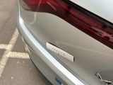 a sticker on the back of a silver car