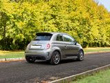 a small car that is driving down the road