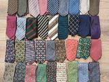 many different types of ties laid out on the floor