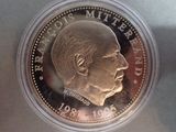 a close up of a coin with a man ' s face on it