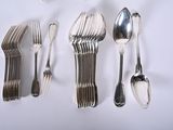 a lot of silver spoons and silverware on a table