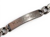 an image of a close up of a metal bracelet with a name on it