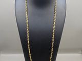 a gold chain necklace on a mannequin display
