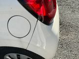 a close up of a car ' s tail light on the side of the road