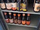 many bottles of beer sitting on a shelf in a store