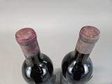 two bottles of wine sitting next to each other on a table