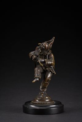 a bronze figure of a man with a bird on his shoulder