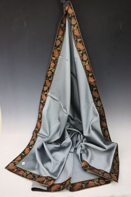 a picture of a blue and brown scarf hanging on a wall