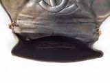 a black purse with a chain hanging from it ' s side