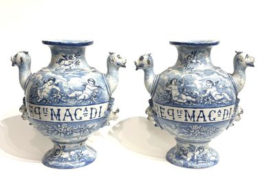 pair of blue and white vases sitting on top of a white surface