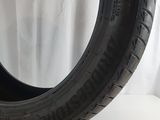 a tire on a white surface with a white curtain in the background