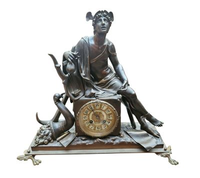 une statue en bronze représentant une femme assise sur une horloge