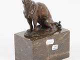 bronze sculpture of a cat sitting on a marble block