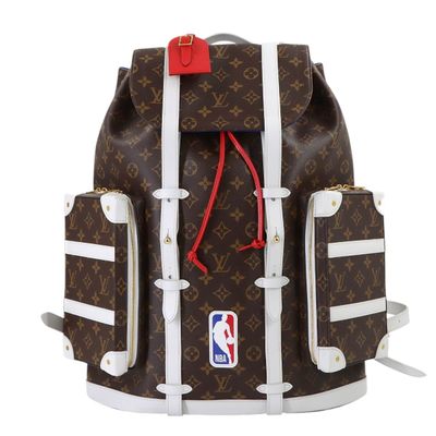 the backpack is brown and white with a red tag on it