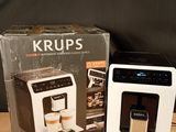 a coffee maker sitting next to a box on a table