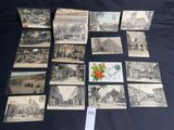 many old postcards on a table with a bunch of them