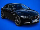 a black jaguar parked in front of a blue background