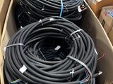several boxes of hoses are stacked on top of each other