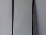 an image of a mirror with a wooden frame on a wall