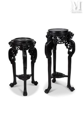 pair of black carved stools with legs and feet